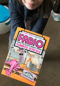 A child holding a copy of Fabio